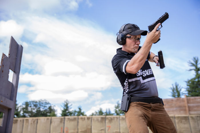 Team SIG professional shooter Daniel Horner drops his mag to reload in pistol competition