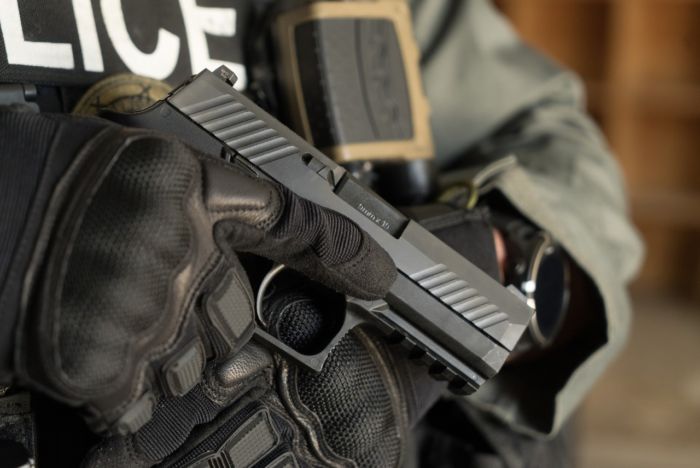 Milwaukee Police Officer holding the newly aquired SIG P320 duty firearm