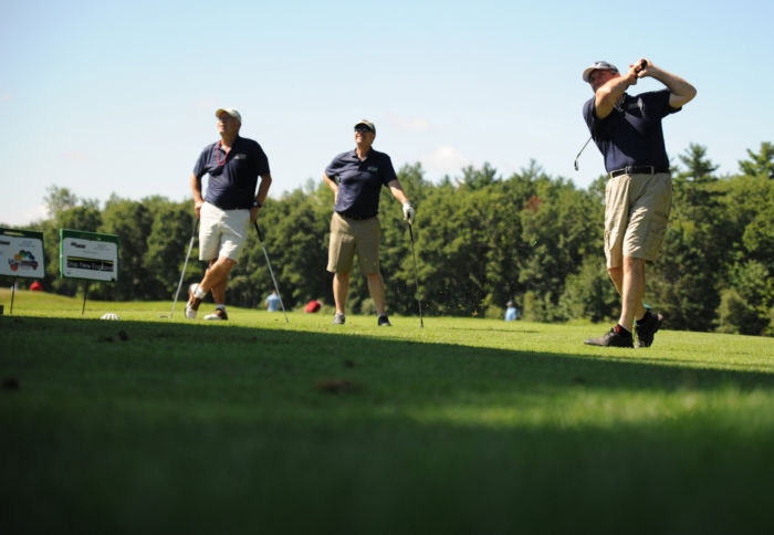 Three men golfing for the HAVA organization's SIG SAUER sponsored event