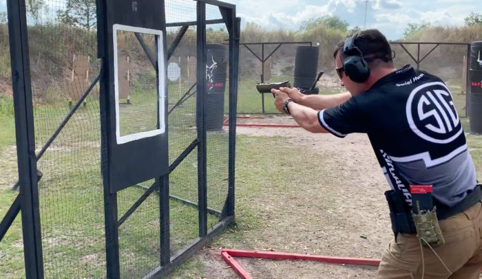 Team SIG professional shooter Daniel Horner fires a pistol at the USPSA