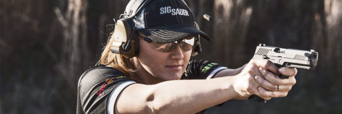 Team SIG member, Lena Miculek aims her pistol in competition