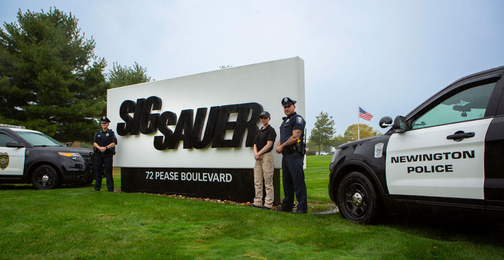 Newington NH Police officers pose at the SIG SAUER Worldwide Headquarters Newington NH
